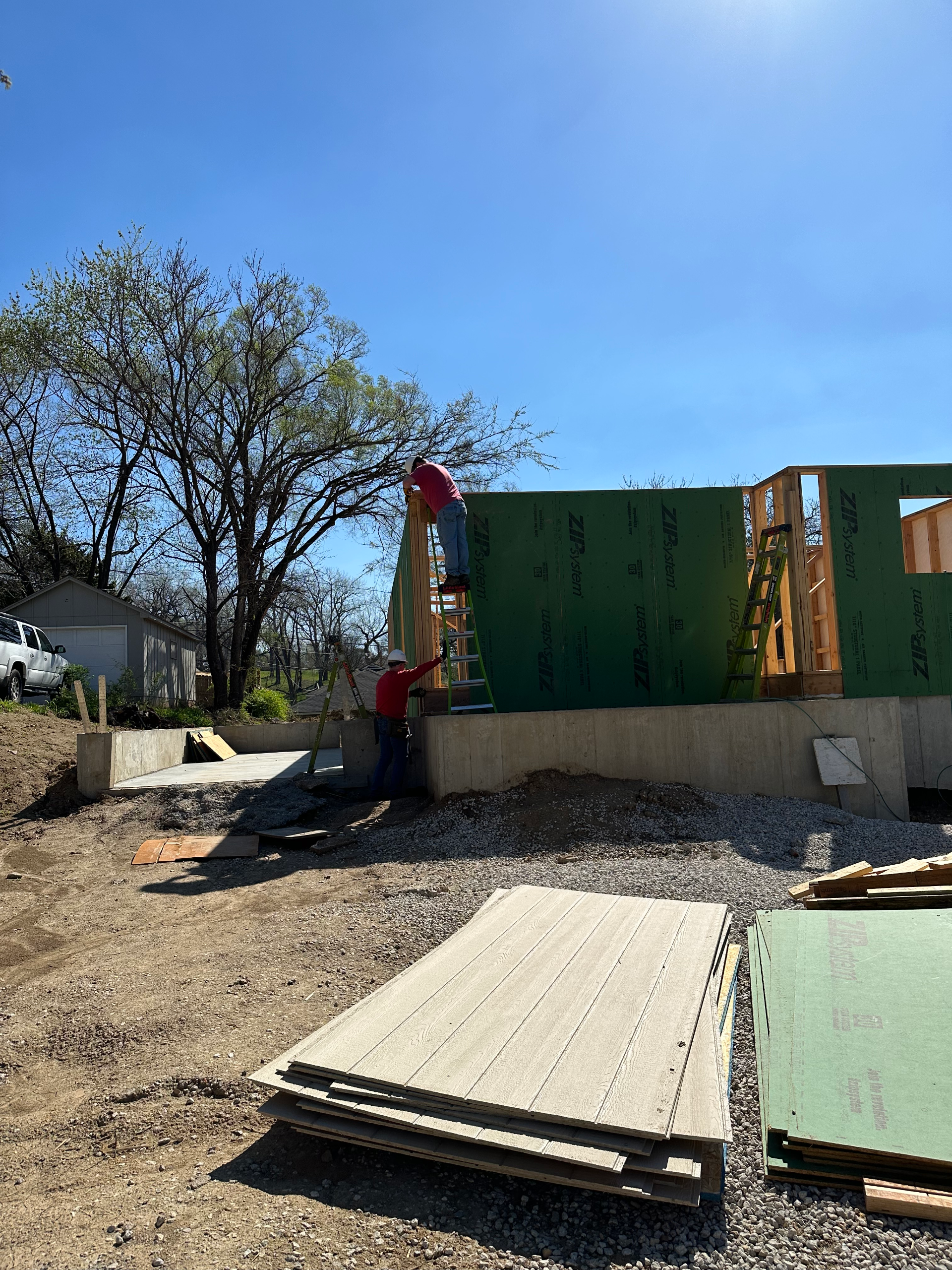 Kevin working on an exterior wall of a Habitat for Humanity house.