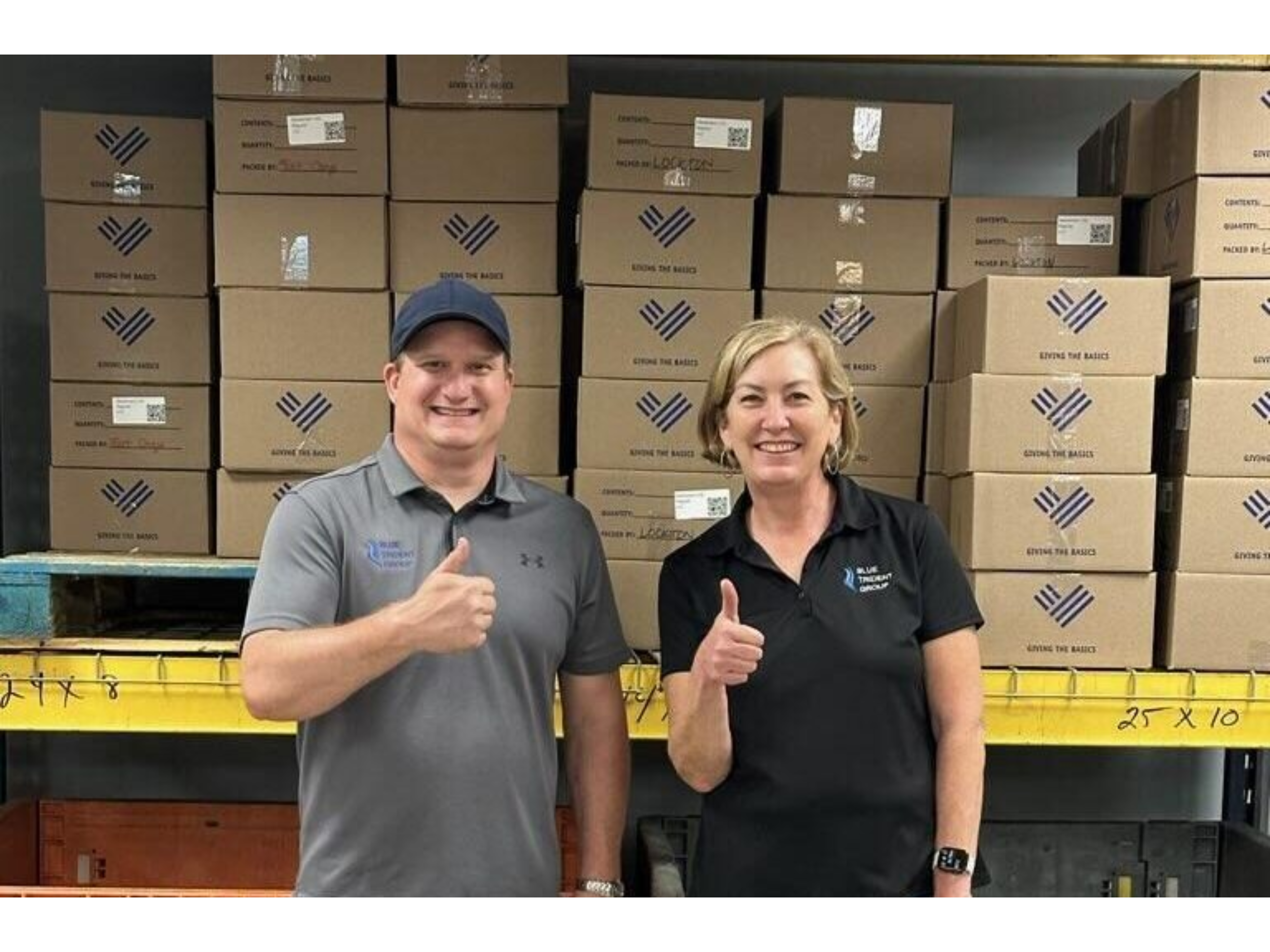 Kevin and Jill in the Giving the Basics warehouse.