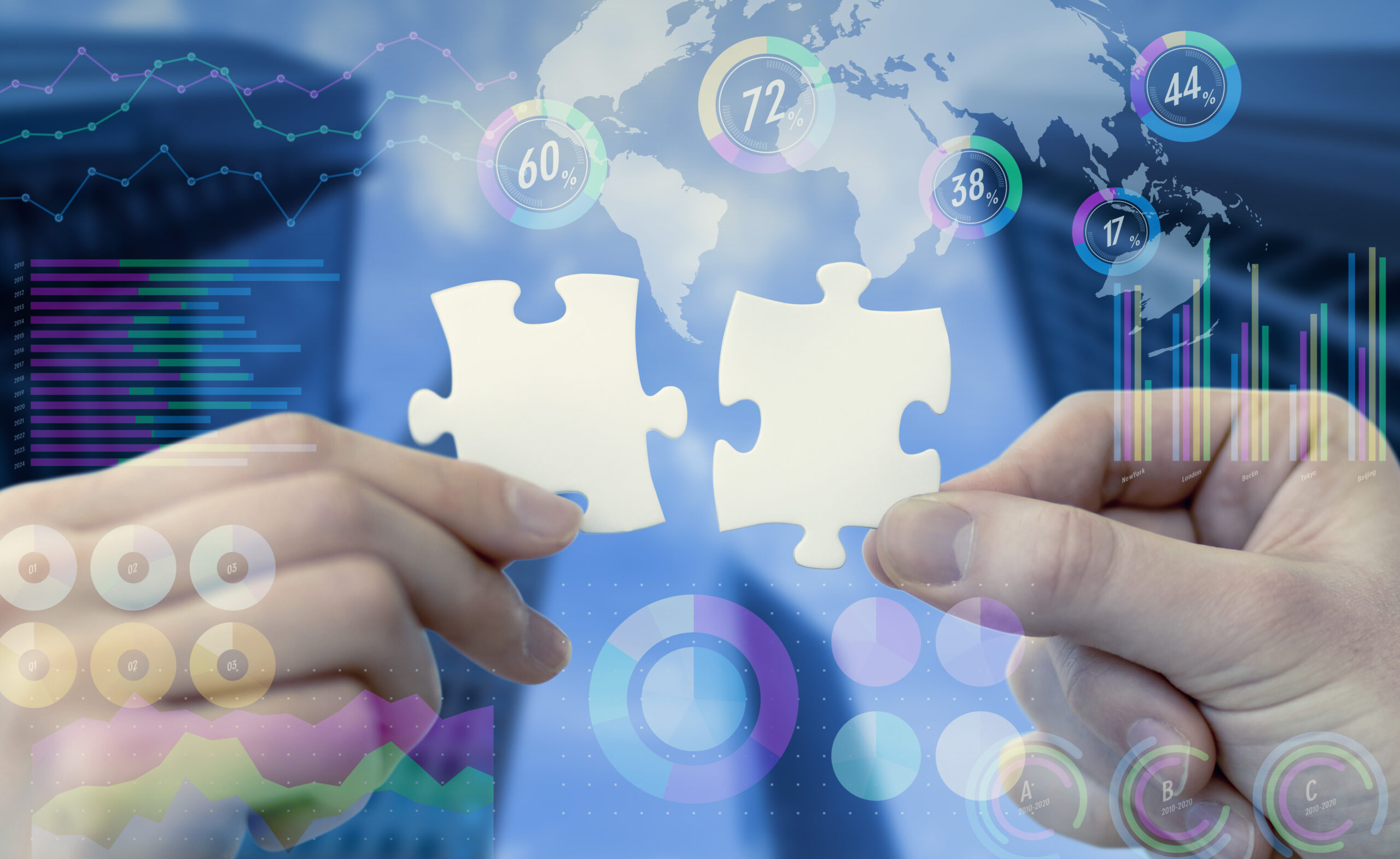 Hands holding two puzzle pieces in front of various graphs and statistics.